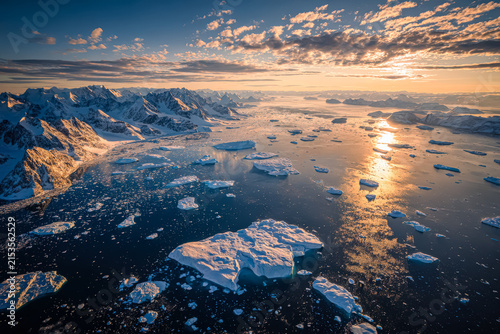 Aerial View of Arctic Glacier Melting into Ocean at Sunset