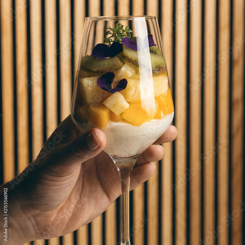 Elegant Hand-Held Tropical Fruit Glass with Mango, Kiwi, and Edible Flowers