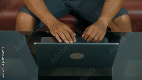 Closeup of man hands using touchpad on laptop keypad. Unrecognized freelancer browsing internet computer doing online report in agency. Student employee study remotely at desk.