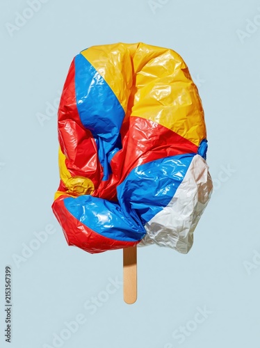 Deflated Beach Ball Ice Pop with Blocky Folded Panels on Pale Sky Blue Background