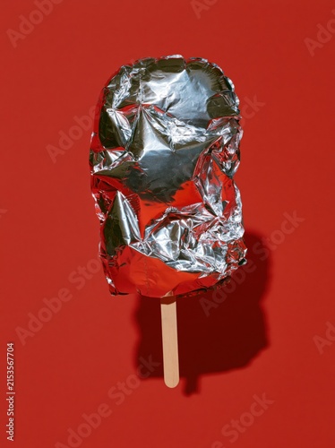 Metallic Balloon Ice Pop with Pointed Reflective Folds on Cherry Red Background