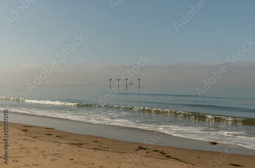 Scenic vista of old piling relics off the Pacific coast in Goleta, Santa Barbara County, Southern California 