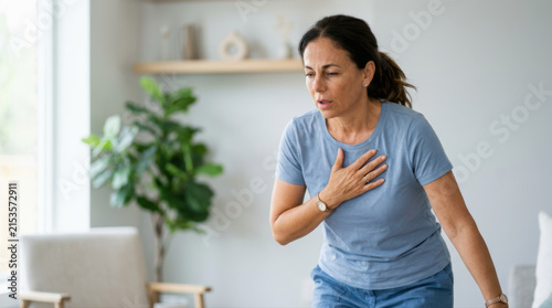 Woman chest pain middle aged woman female health heart problem home interior shortness breath emergency medical concept worried expression casual clothing woman chest pain and shortness breath