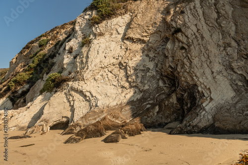 Scenic cliffs at the Pacific coast in Goleta, Santa Barbara County, with rocks at the bottom brown from natural oil seepage, Southern California