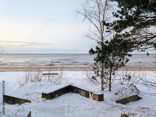 Snowy beach and calm sea in winter morning, Jurmala, Latvia