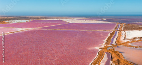 Cuadro en lienzo An aerial perspective shows the vibrant pink salt flats and water evaporation ponds at Walvis Bay in Namibia, separated by earth pathways