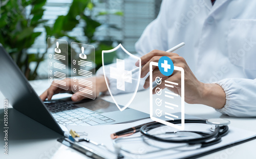 Healthcare professional manages secure digital patient records on laptop, illustrating medical data protection, cybersecurity, privacy, healthcare compliance, information security, and safe technology