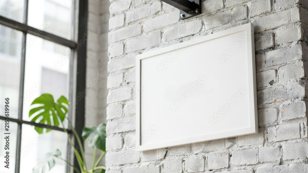 Fototapeta premium Empty white rectangular frame on a painted white brick wall