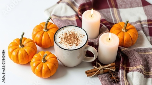 Cozy Autumn Pumpkin Spice Latte Mug with Lit Candles Cinnamon Sticks and Small Pumpkins on Plaid Scarf