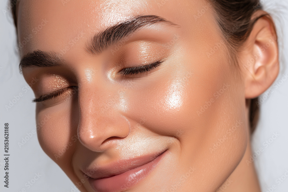 Obraz premium Luminous hydrated skin close up portrait glowing cheek natural makeup golden sunlight