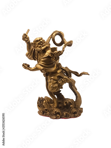 Golden bronze statue of Chinese deity Kuixing god of examinations stepping on monster fish isolated on white background.