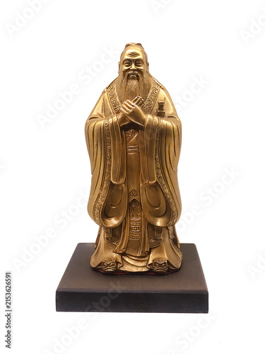 Golden bronze statue of ancient Chinese philosopher Confucius clasping hands on pedestal isolated on white background.