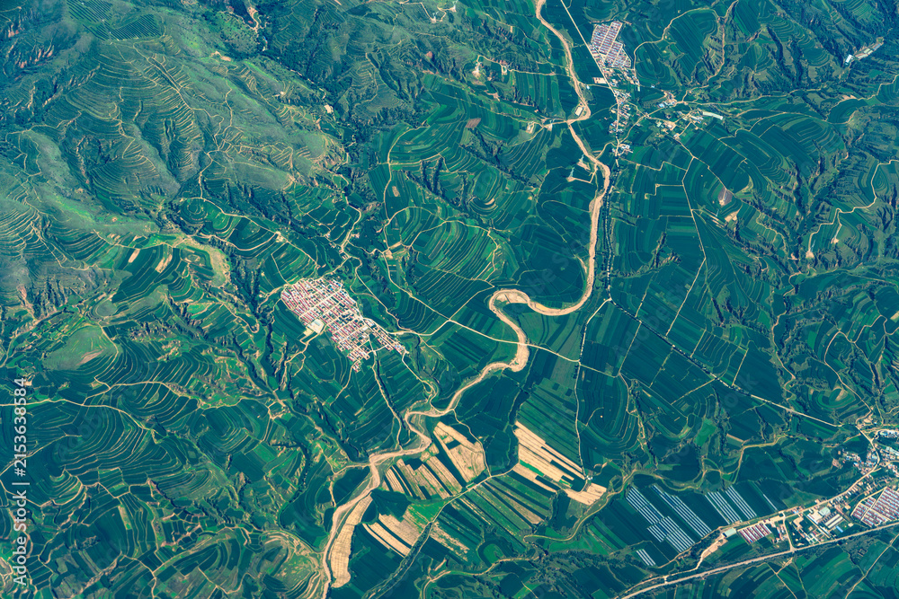 Obraz premium aerial view of green agriculture field in mountain area