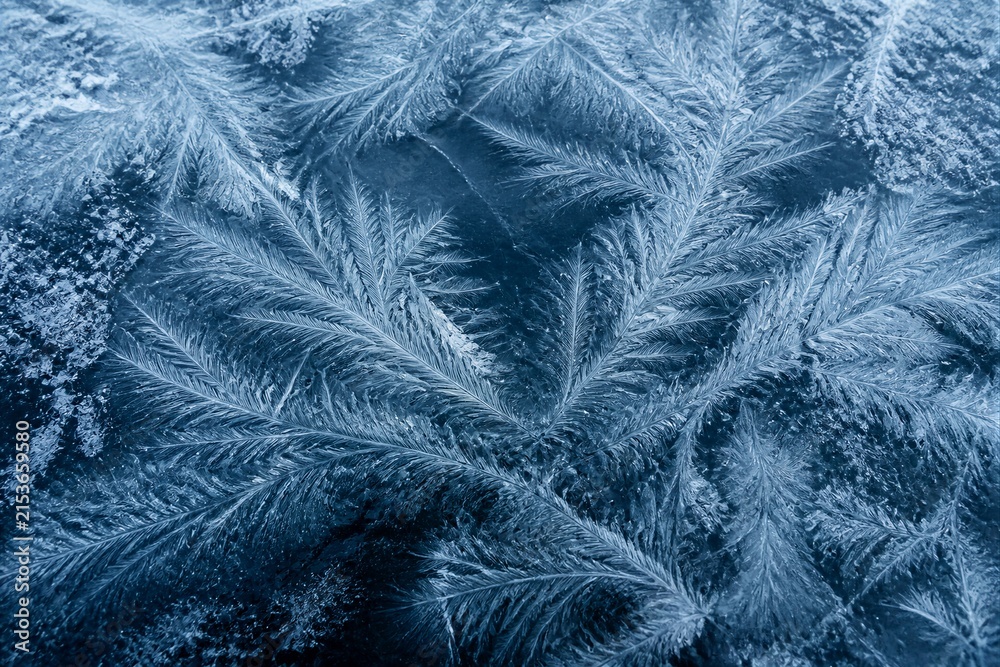 Obraz premium Frost crystals forming feather patterns on cold window