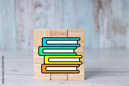 Concepts of studying, back-to-school, learning, note-taking, office work, and books on wooden cubes.