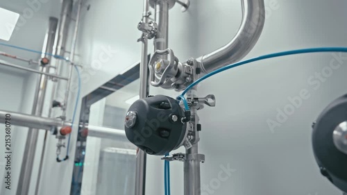 Factory machine at work. Production equipment at medical industry. Pipes, valves, and gauges. Close-up in 4K, UHD