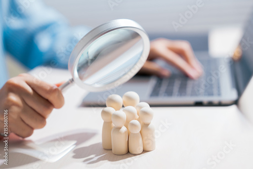 Customer analysis concept. Magnifying glass examining people for target audience research and selection; customer, demographic, research, HR, recruitment