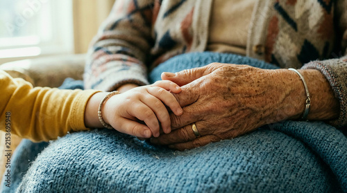 Close Up of Elderly Hand and Child Hand Resting Together on Blue Blanket, Generations Bonding Moment of Comfort and Care