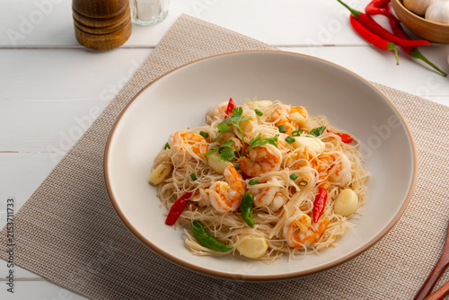 Stir Fried Rice Vermicelli with shrimp and fresh chilli garlic in white plate.
