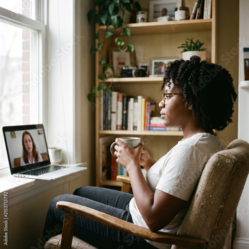 Black Woman Video Calling Therapist in Home Office Nook