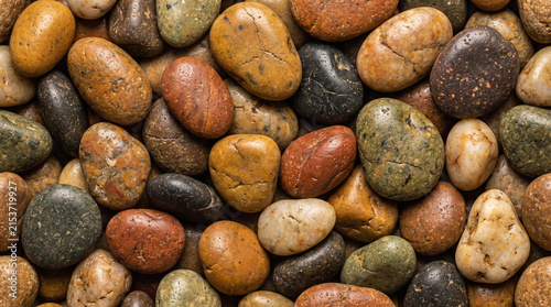 Smooth river stones display a vibrant mix of earthy colors and polished textures in this high resolution natural background scene