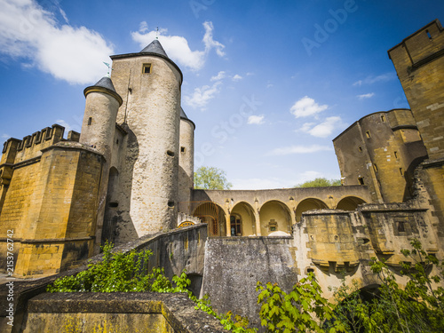 Wide view of the historic Porte des Allemands in Metz, France, photographed on April 26, 2025. Medieval fortified city gate complex with round towers, stone defensive walls, bridge structures and arca