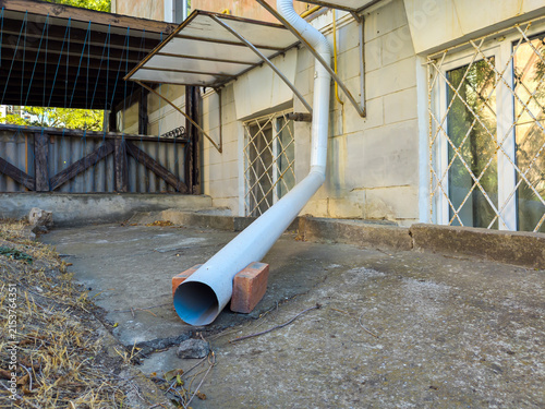 The drainage system outlet is located at the edge of the blind area