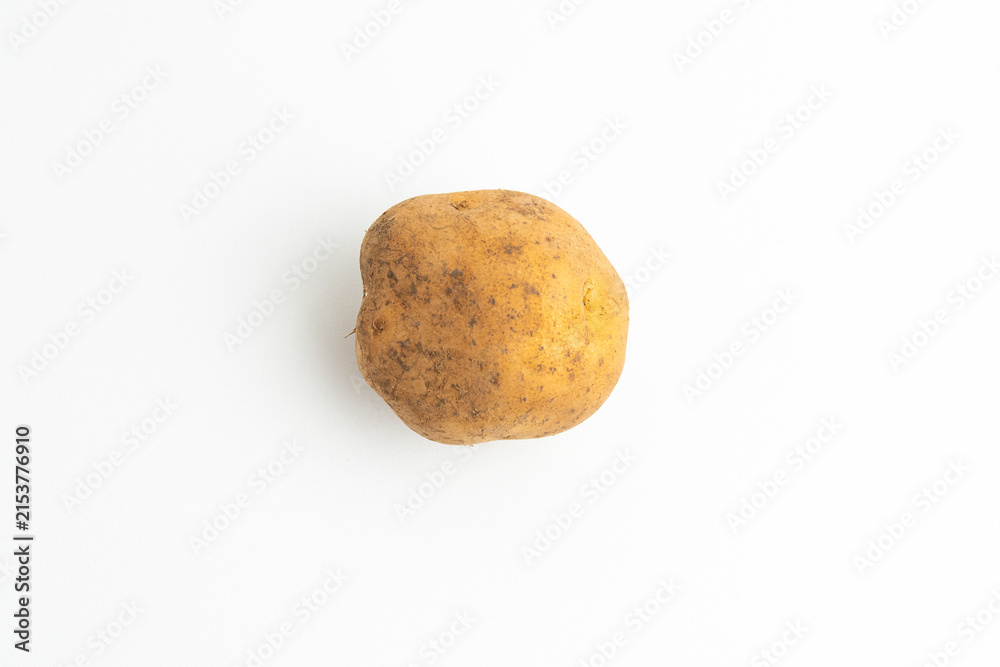 Fototapeta premium Single fresh raw brown baby potato isolated on a white background