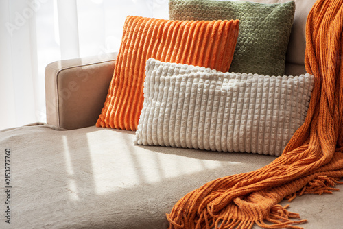 Cozy Sofa Arrangement With Plush Cushions And Knitted Throw For Home Decor Comfort