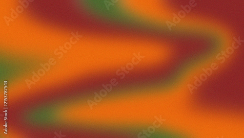 Abstract grainy gradient background with orange, red and green blurred wavy color texture.