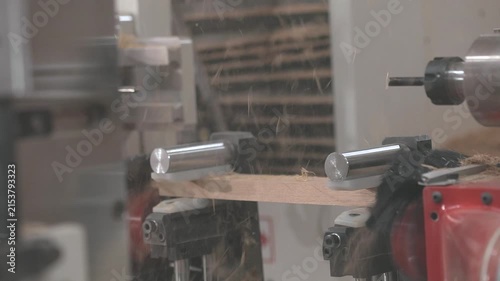 Automated routing process creates an interlocking joint for furniture manufacturing and wood assembly. CNC woodworking machine milling a precision edge profile on a wooden board.