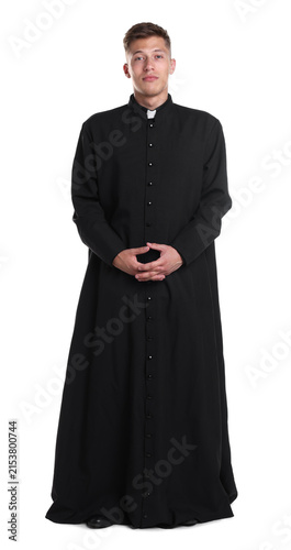Young priest in cassock on white background