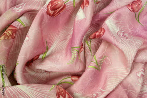 lush drapery of pink silk fabric with red tulip pattern