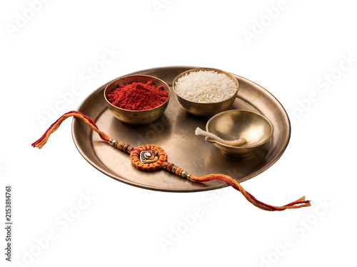 Minimal Raksha Bandhan thali featuring traditional rakhi, red roli, rice and brass diya, isolated as a transparent PNG element for Indian festival designs.