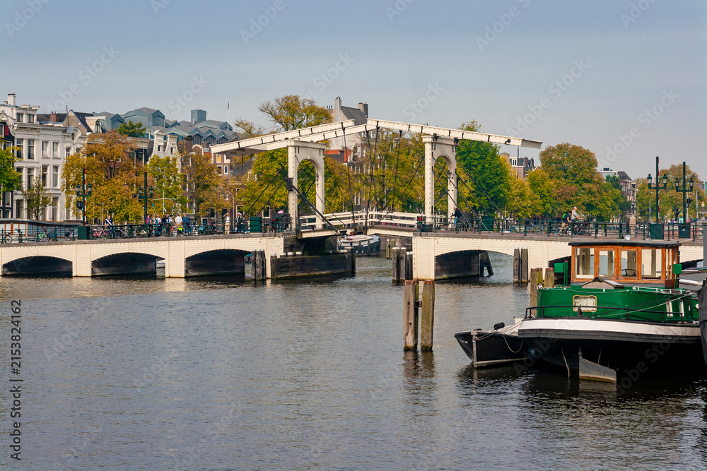 Fototapeta premium Traditional historic wooden drawbridge Magere Brug over Amstel river in Amsterdam Netherlands