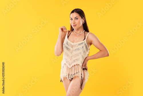 Konstfotografi Beautiful woman in stylish beachwear on orange background