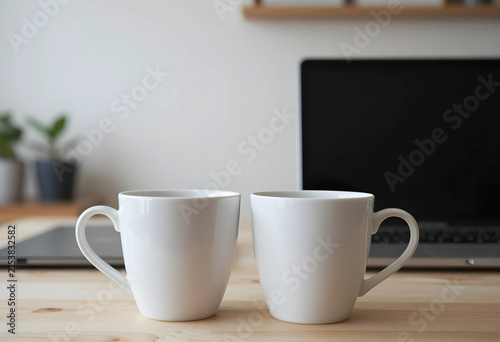 Two white ceramic coffee mu...