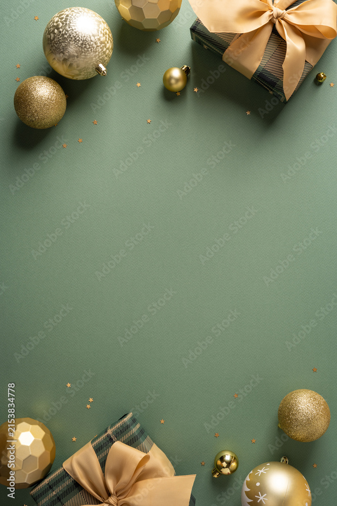 Naklejka premium Golden Christmas ornaments and wrapped gifts on sage vertical green background for Merry Christmas and Happy New Year