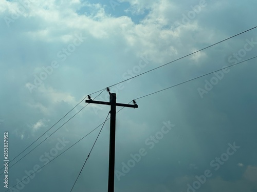 Electrical Power Lines Running Along a Rural Landscape With Utility Infrastructure and Open Sky