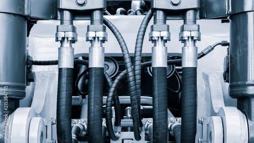 Bundle of pipes connected to industrial hydraulic pneumatic machine, tech industrial technology background