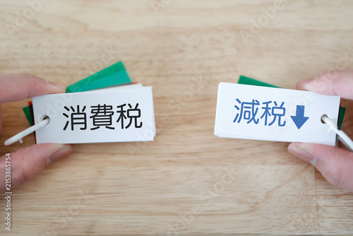 Fotografie 消費税と減税。カード表示と下矢印。家計・税金イメージ