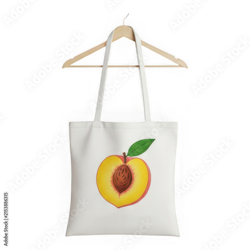 Peach hanging from tote bag handle