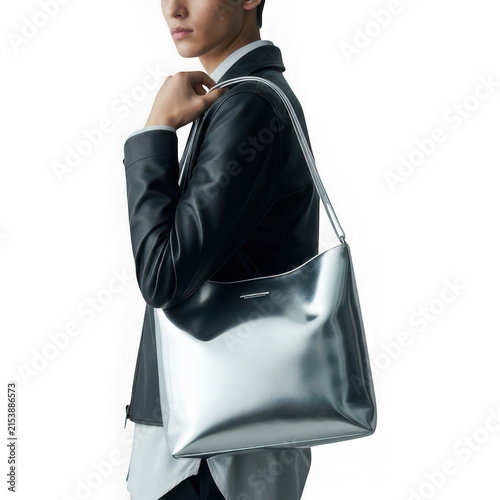 Woman carrying stylish gray tote bag walking outdoors