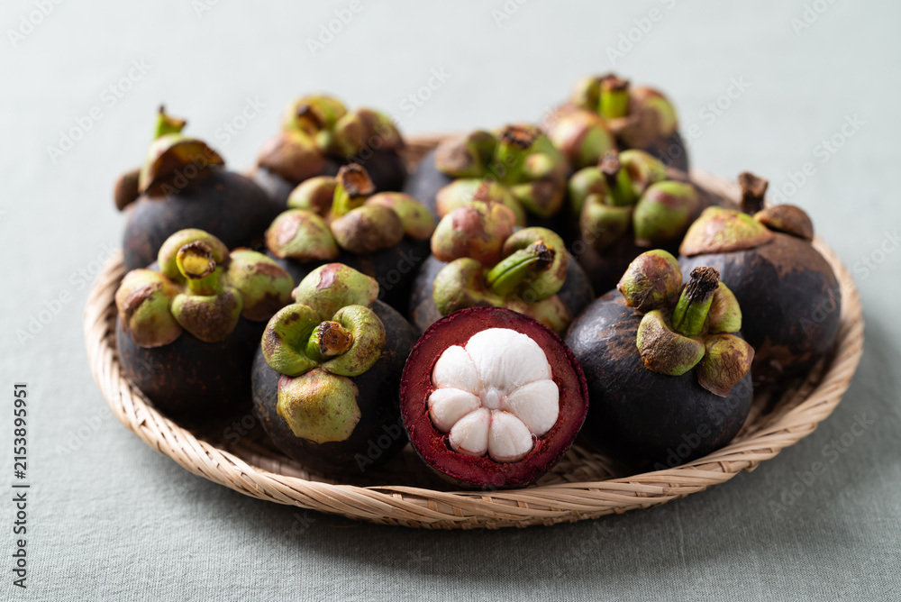 Fototapeta premium Fresh mangosteen in wicker plate, Tropical fruit in Thailand