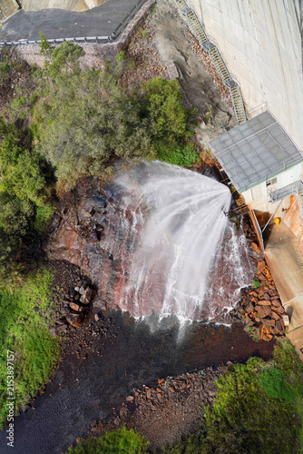 Water spilling from Moogerah Dam spillway into rocky creek in Queensland Australia