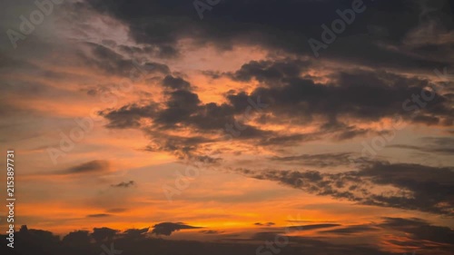 Stunning golden hour clouds drifting across a dramatic orange sunset sky 4k footage featuring peaceful atmosphere and ethereal light movement for atmospheric cinematic backgrounds