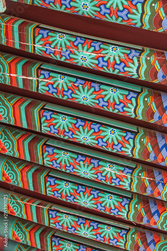 Konstfotografi Close-up of colorful dancheong floral patterns on traditional wooden rafters of a Korean Buddhist temple in South Korea
