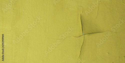 Cracked and peeling texture of yellow wall paint