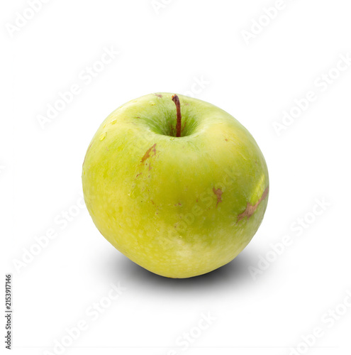 Canvas Print Ripe green apple with stem casting a soft shadow on white backdrop