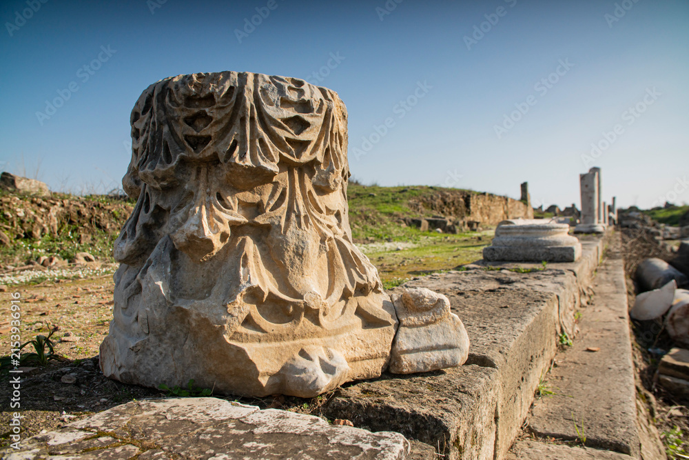 Fototapeta premium Ornate ancient Roman marble column capital with floral carved relief archaeological site in Turkey